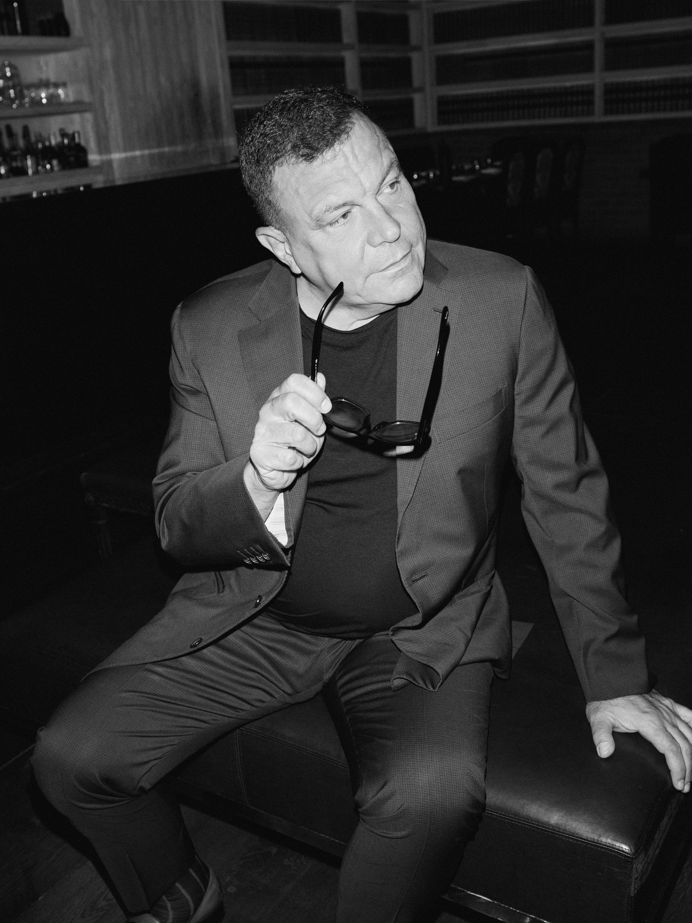 Stephen Starr holding sunglasses, black and white portrait
